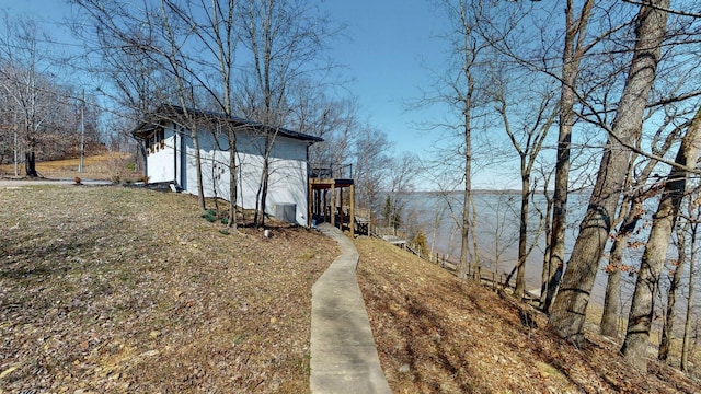 view of yard with a deck with water view