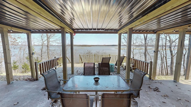 view of patio featuring outdoor dining area and a water view