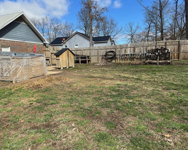 view of yard with an outbuilding and a fenced backyard