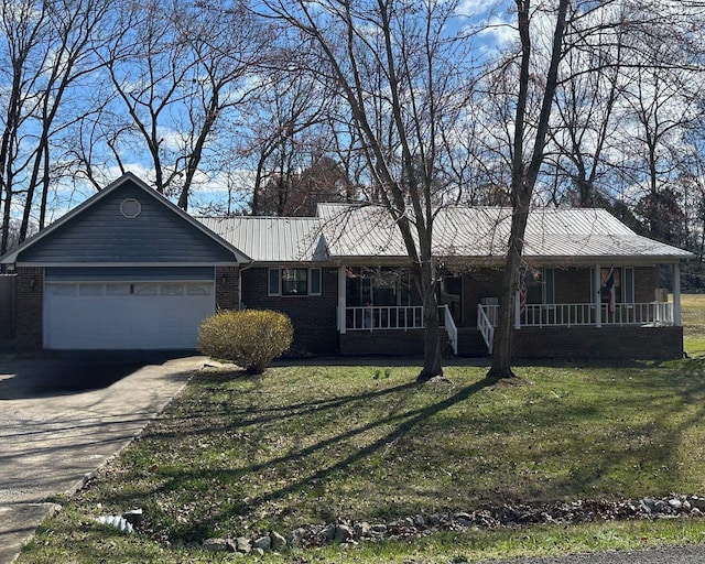 single story home featuring a porch, an attached garage, brick siding, driveway, and a front yard