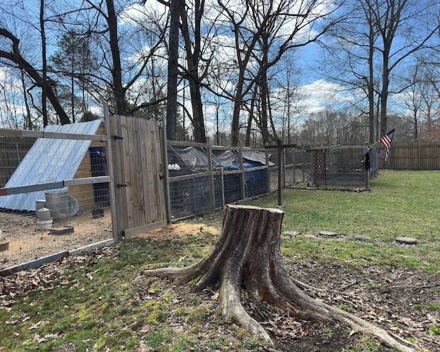 view of yard featuring an outbuilding, a fenced backyard, and exterior structure