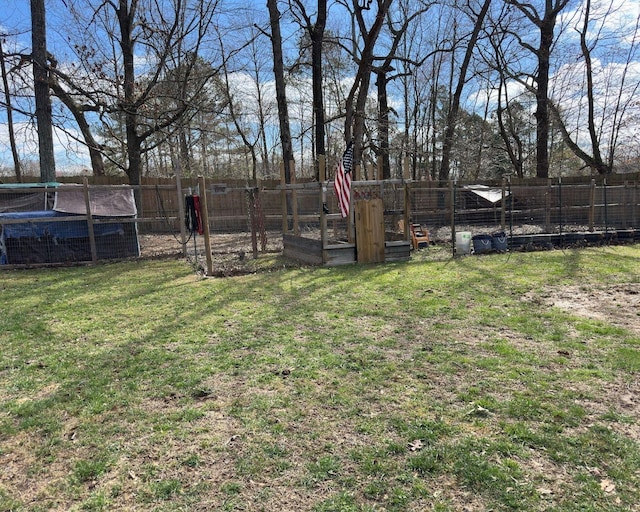 view of yard featuring an outdoor structure, fence, and exterior structure