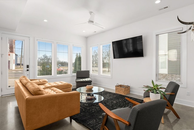 living room featuring baseboards, visible vents, a ceiling fan, and recessed lighting