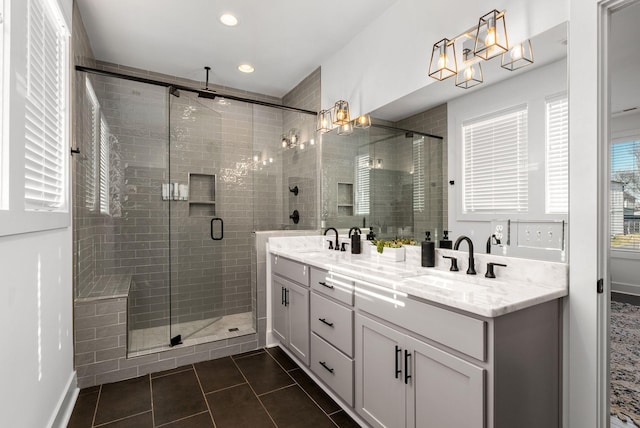 full bathroom featuring double vanity, tile patterned flooring, a sink, and a shower stall