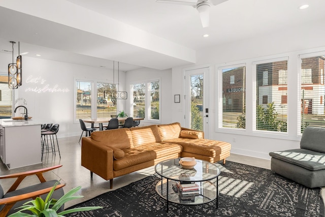 sunroom with ceiling fan and a sink