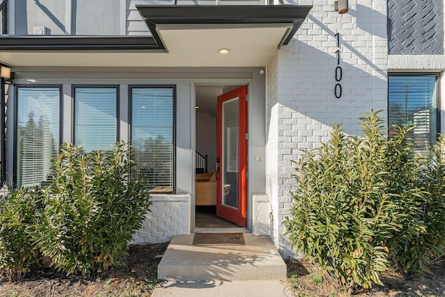 property entrance featuring brick siding