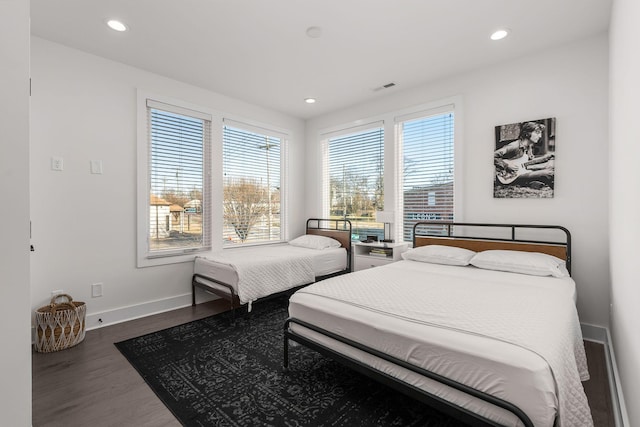 bedroom with recessed lighting, wood finished floors, visible vents, and baseboards