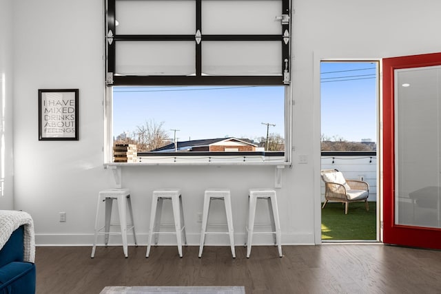 interior space featuring baseboards and wood finished floors