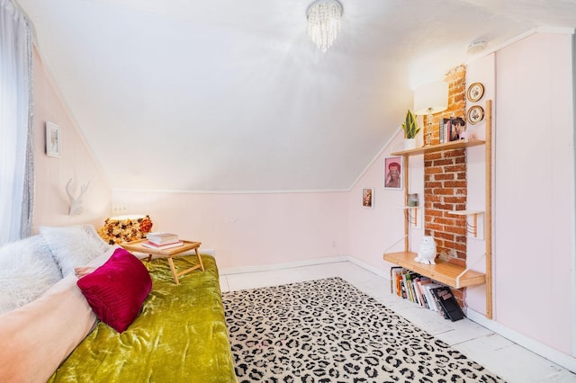 bedroom with baseboards and lofted ceiling