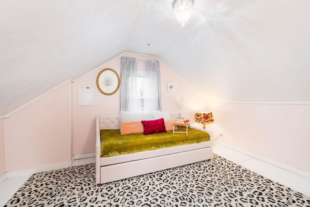 bedroom with baseboards and lofted ceiling