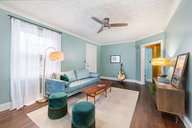 living area featuring a textured ceiling, wood finished floors, ceiling fan, and crown molding