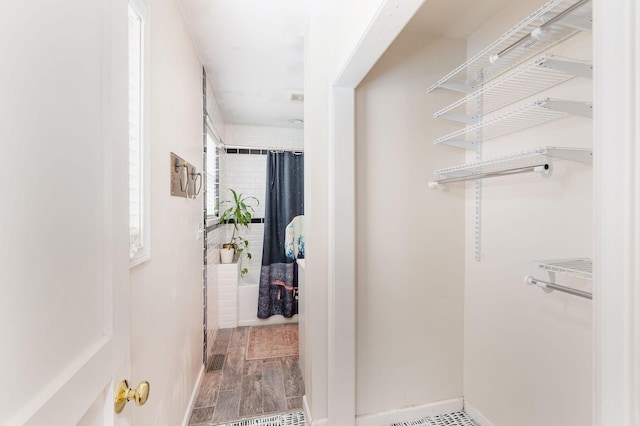 spacious closet with wood finished floors