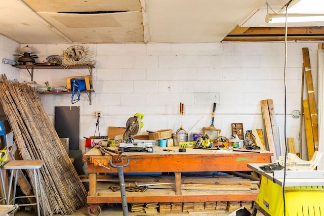 interior space featuring concrete block wall and a workshop area