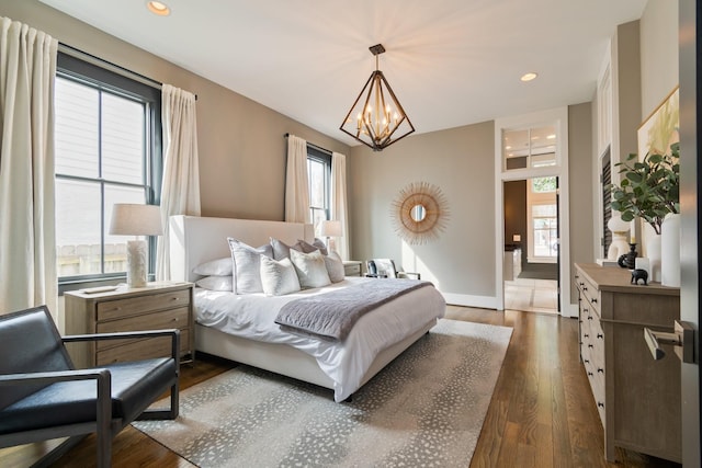 bedroom with a chandelier, dark wood-style flooring, recessed lighting, and baseboards