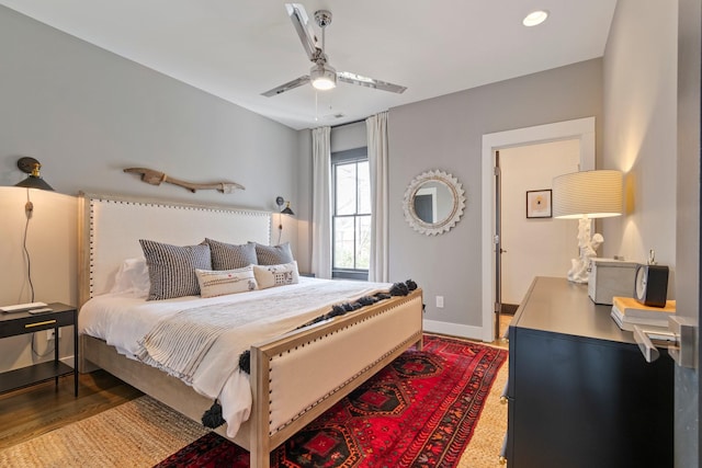 bedroom with ceiling fan and baseboards