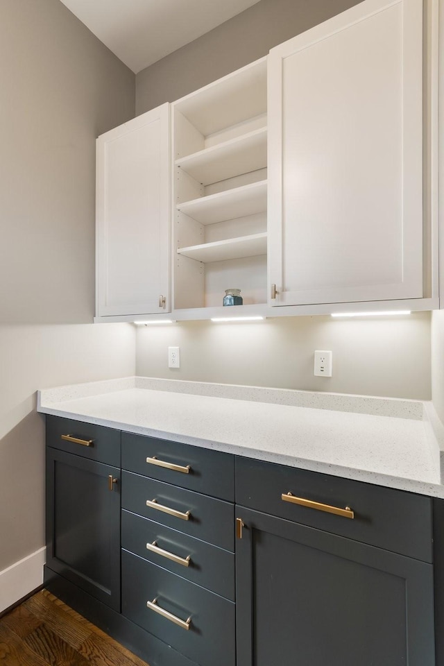 bar with dark wood-type flooring and baseboards