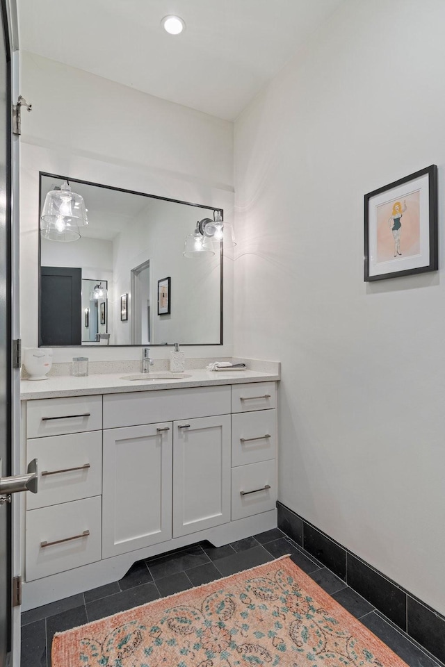 bathroom featuring tile patterned flooring, vanity, and baseboards