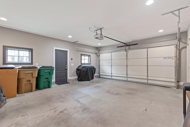 garage featuring a garage door opener and recessed lighting