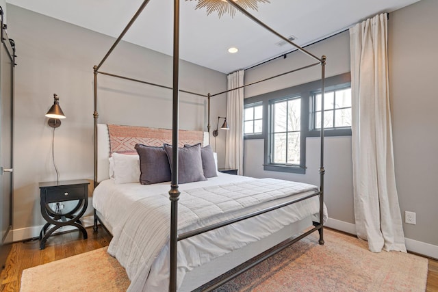 bedroom featuring baseboards and wood finished floors