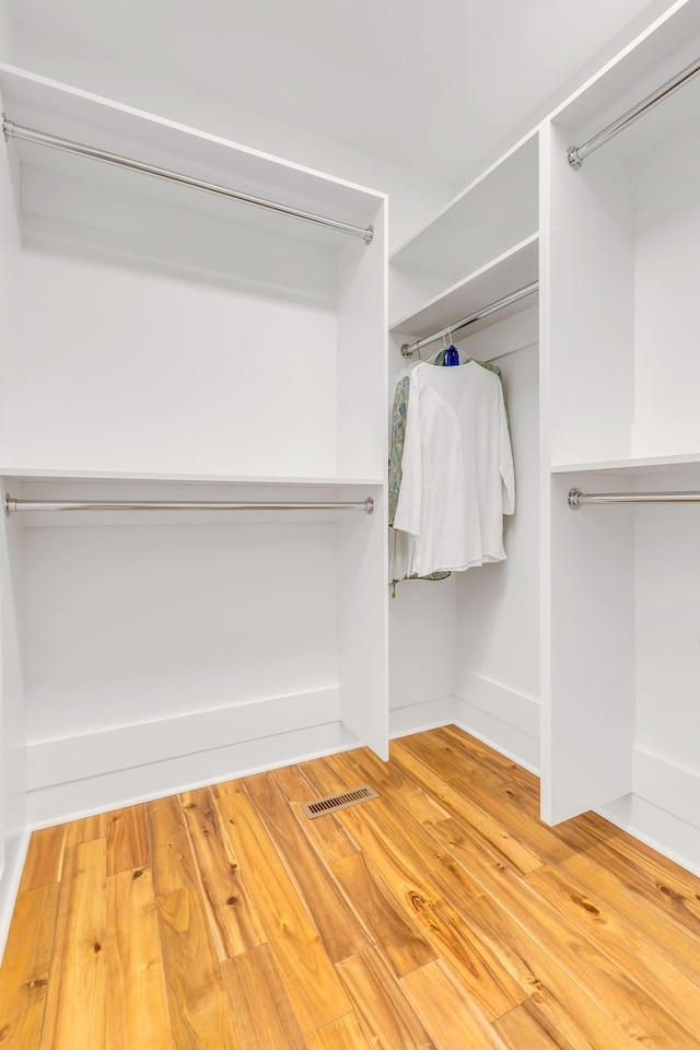 walk in closet featuring visible vents and wood finished floors