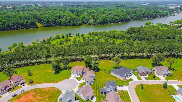 drone / aerial view with a water view, a residential view, and a view of trees