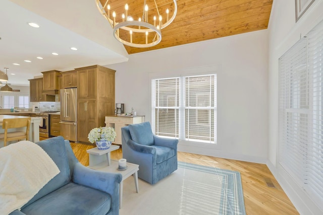 sitting room with light wood-style floors, recessed lighting, baseboards, and an inviting chandelier