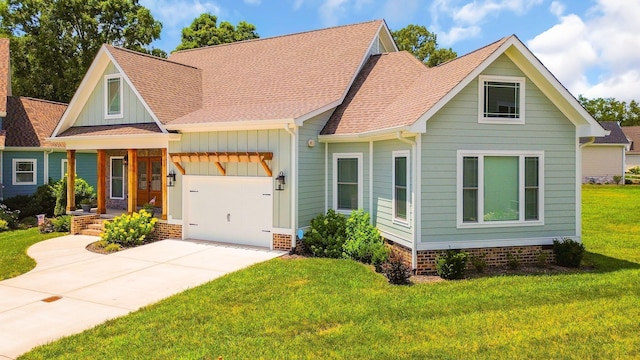 view of front of home featuring a garage, a shingled roof, concrete driveway, a front lawn, and board and batten siding