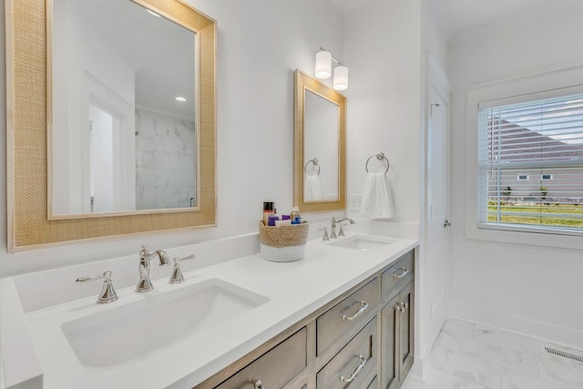 bathroom with double vanity, marble finish floor, visible vents, and a sink
