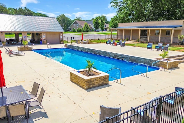 view of pool with a fenced in pool, fence, and a patio