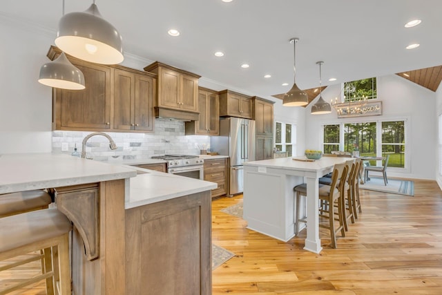 kitchen featuring a breakfast bar area, high end appliances, lofted ceiling, tasteful backsplash, and brown cabinetry