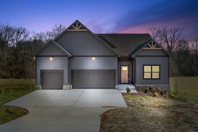 view of front of home with concrete driveway, an attached garage, and board and batten siding