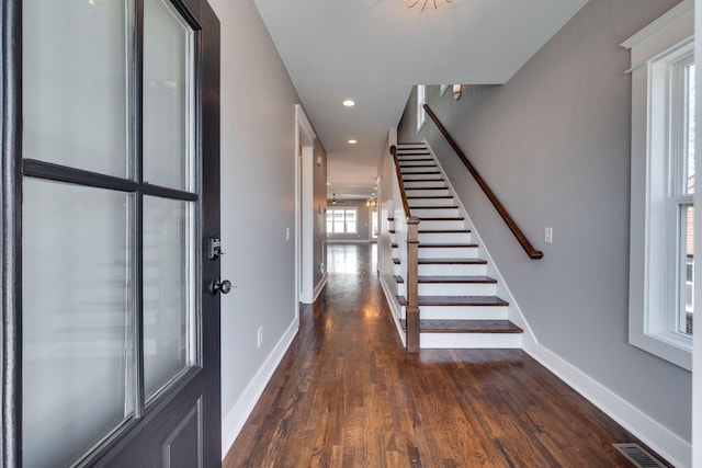 entryway with recessed lighting, wood finished floors, visible vents, baseboards, and stairs