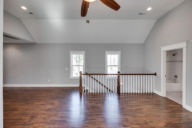 empty room with recessed lighting, visible vents, vaulted ceiling, and wood finished floors