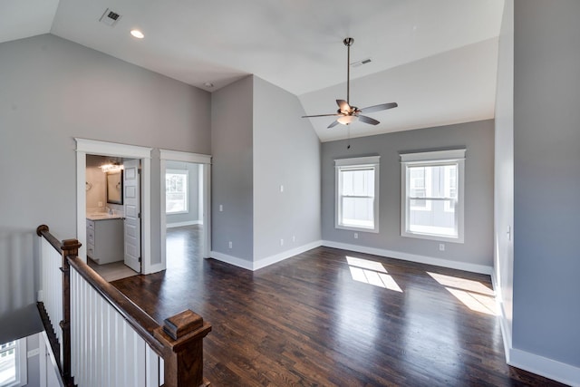 unfurnished living room featuring plenty of natural light, visible vents, and dark wood-type flooring