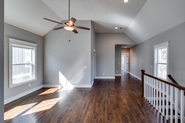 spare room featuring baseboards, ceiling fan, wood finished floors, vaulted ceiling, and recessed lighting