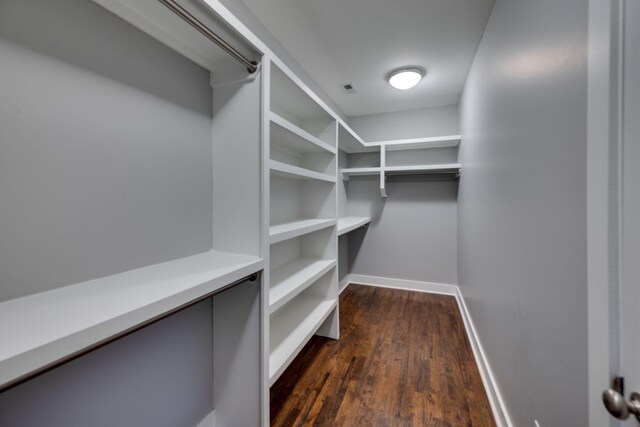 walk in closet featuring dark wood-style floors and visible vents