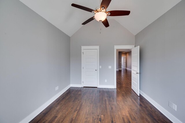 unfurnished bedroom with lofted ceiling, ceiling fan, wood finished floors, and baseboards