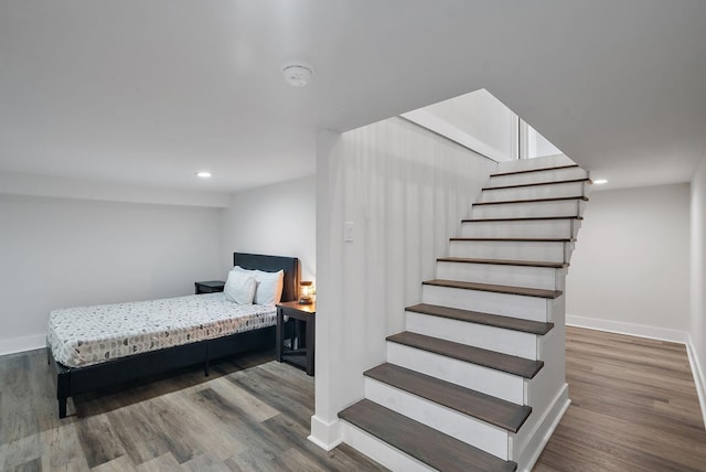 bedroom featuring wood finished floors and baseboards