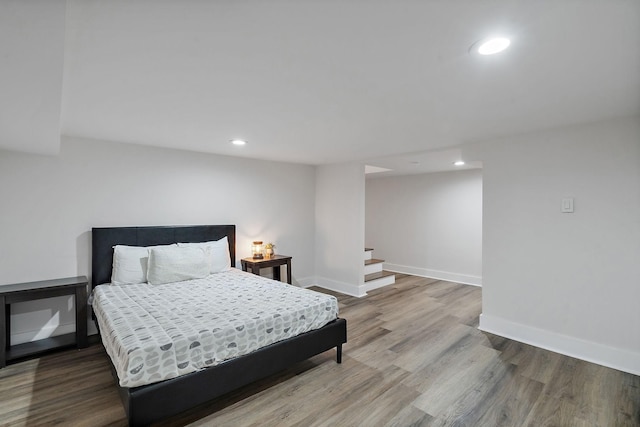 bedroom featuring recessed lighting, wood finished floors, and baseboards