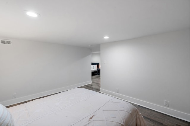 bedroom featuring recessed lighting, wood finished floors, visible vents, and baseboards