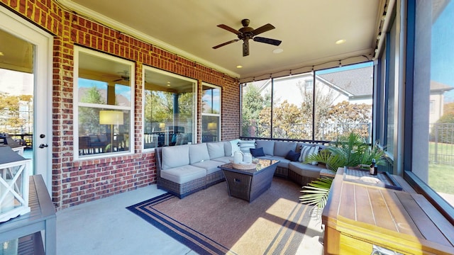 sunroom featuring a ceiling fan