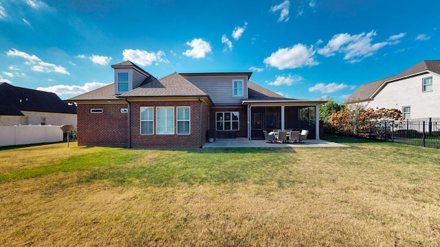 rear view of property featuring a yard, a fenced backyard, and a patio