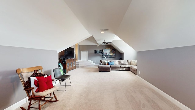 interior space featuring a ceiling fan, visible vents, vaulted ceiling, and baseboards