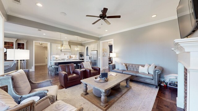 living room featuring ceiling fan with notable chandelier, wood finished floors, and recessed lighting