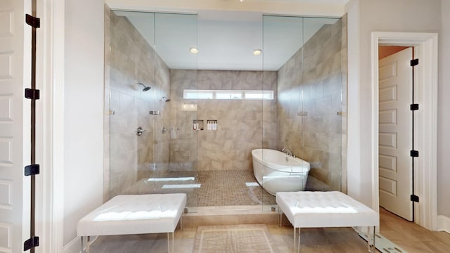 bathroom featuring a soaking tub and walk in shower