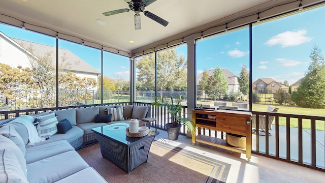 sunroom / solarium with plenty of natural light and a ceiling fan