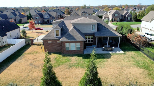 rear view of property with a patio, a fenced backyard, and a residential view