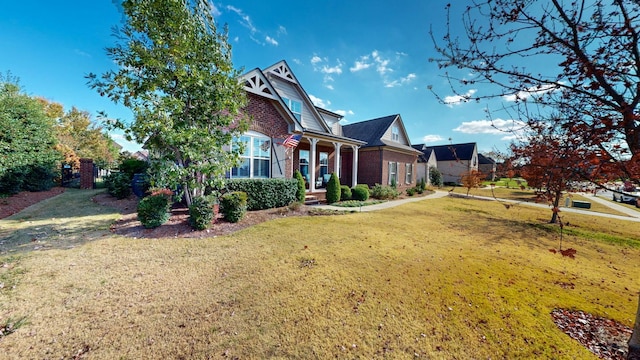 view of front facade with a front lawn and brick siding