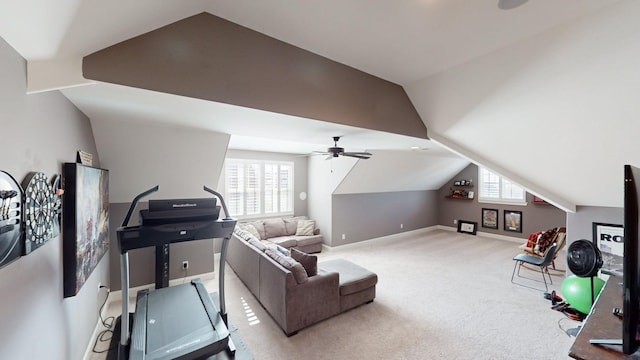 exercise room with lofted ceiling, carpet flooring, a ceiling fan, and baseboards