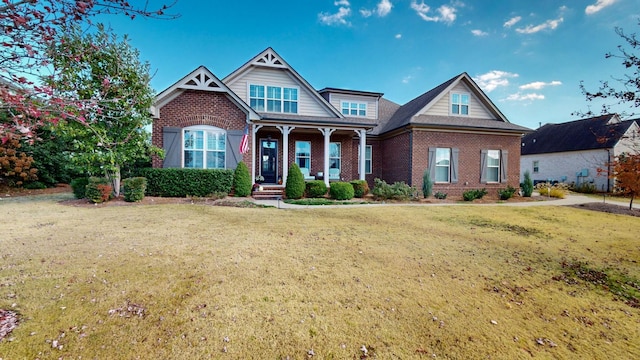 view of front facade with brick siding and a front lawn